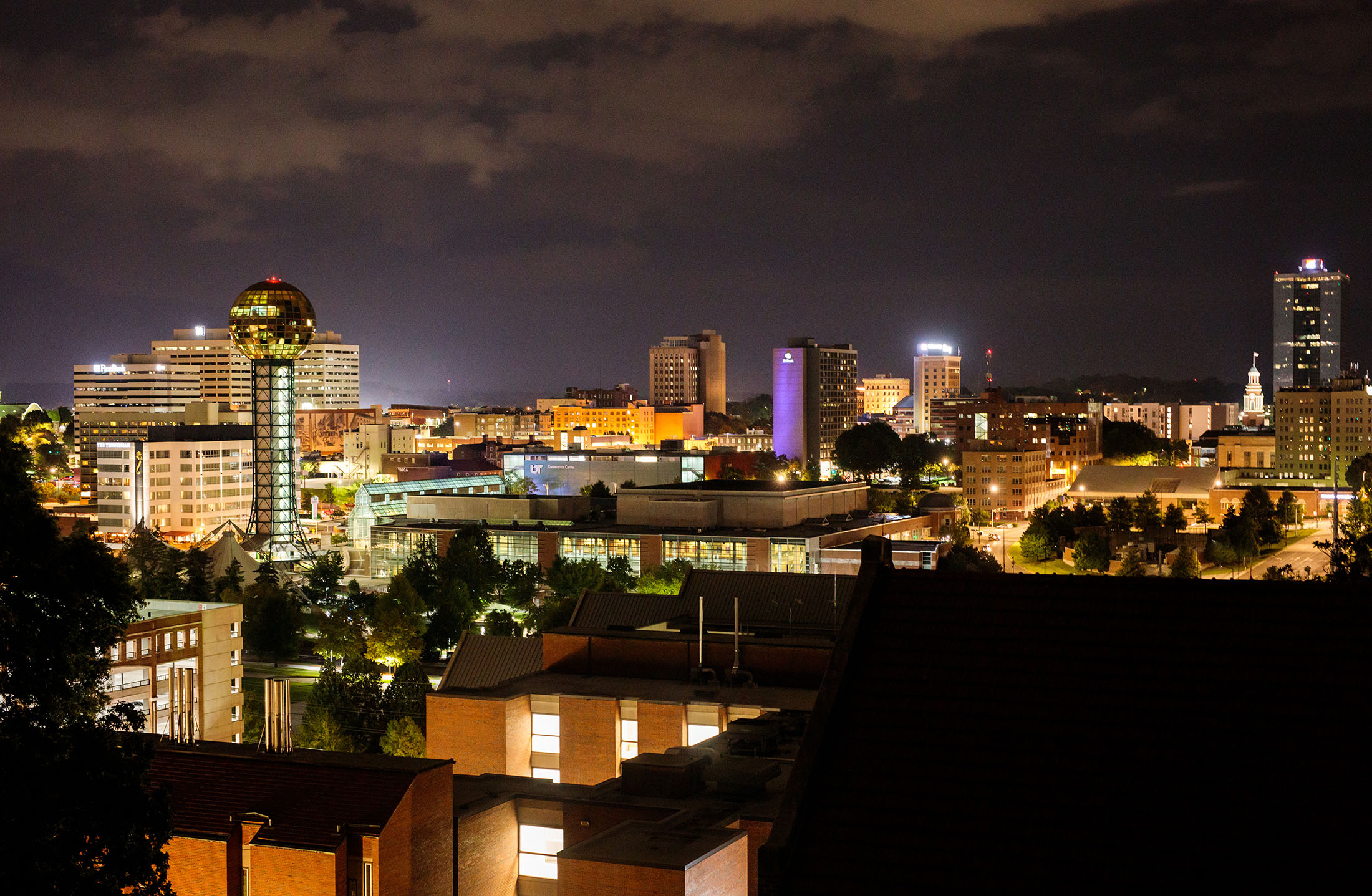 Downtown Knoxville skyline at night including the Sunsphere from the middle roof of Ayres Hall.
