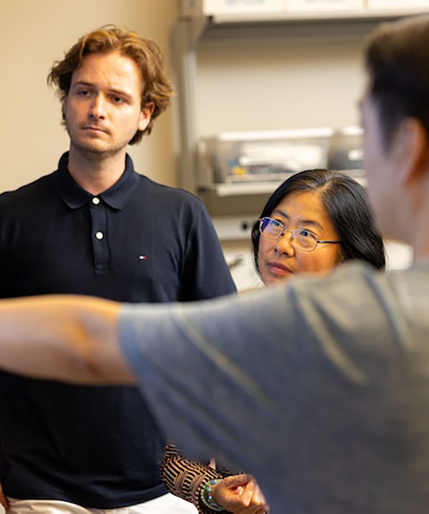 Professor Hairong Qi,  works with students.