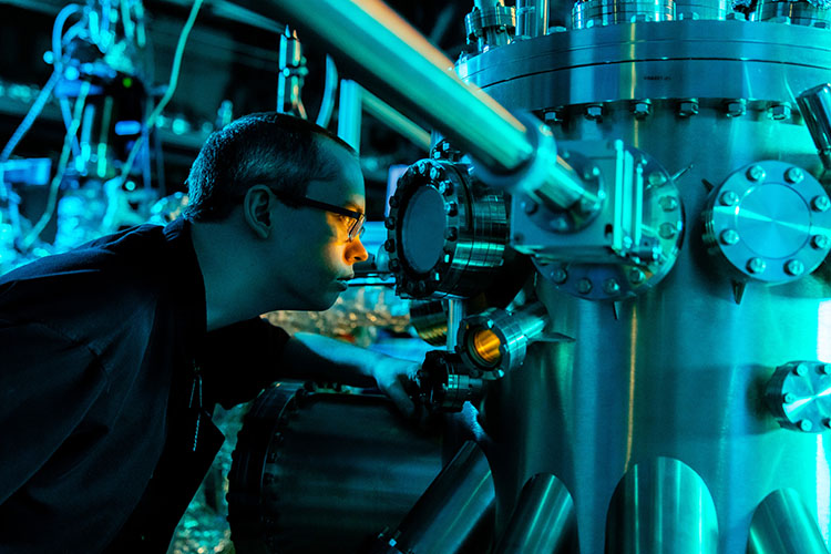 A graduate student works in the Molecular Beam Epitaxy Facility at the University of Tennessee.