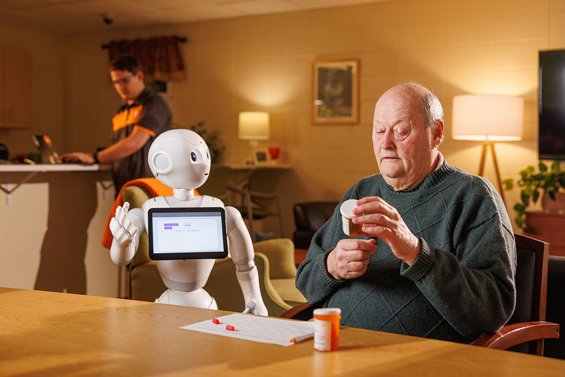 A robot helps a senior in a simulation at a lab at the University of Tennessee.