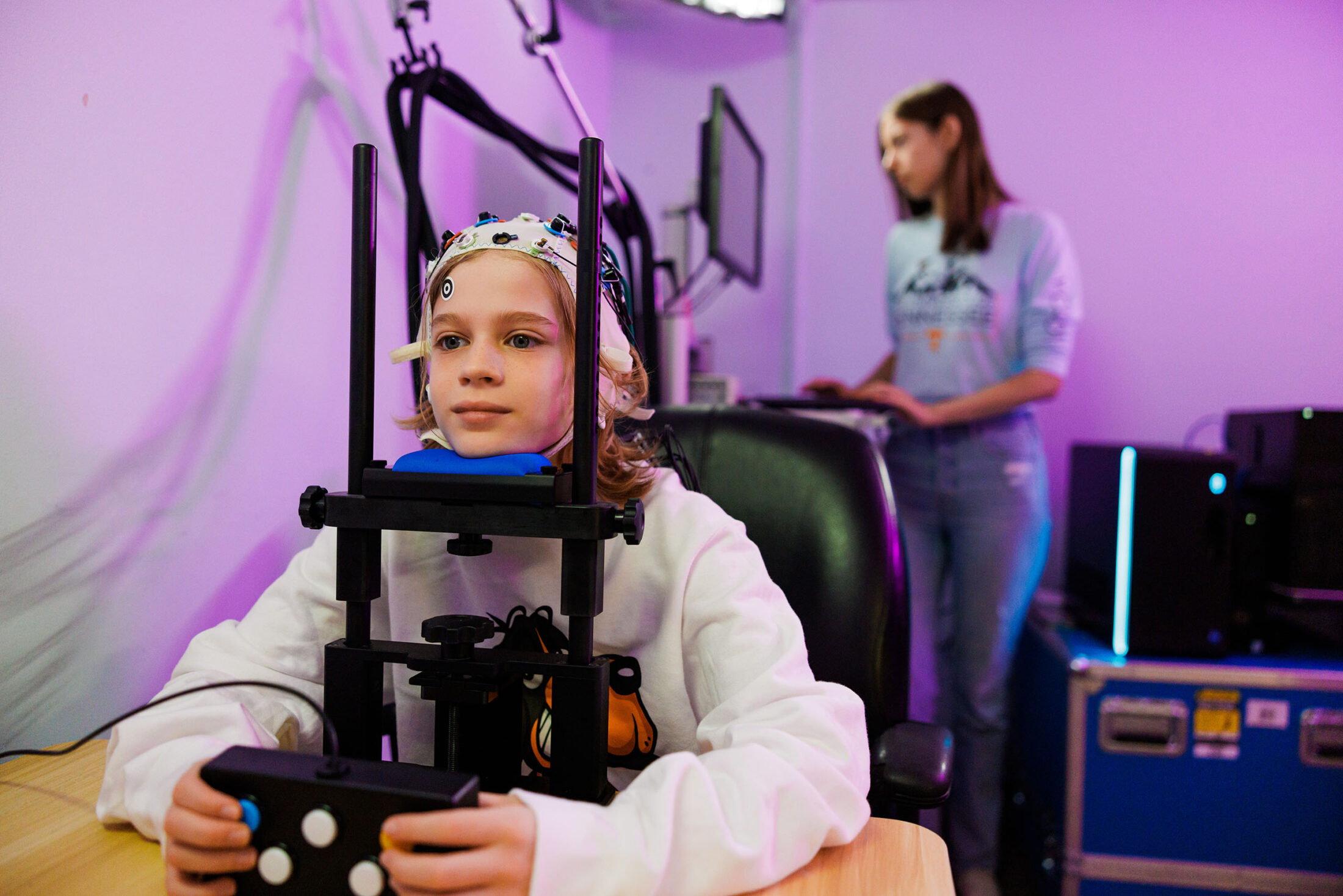 A Phd student ireads eye movements and brain waves of a minor in a lab.