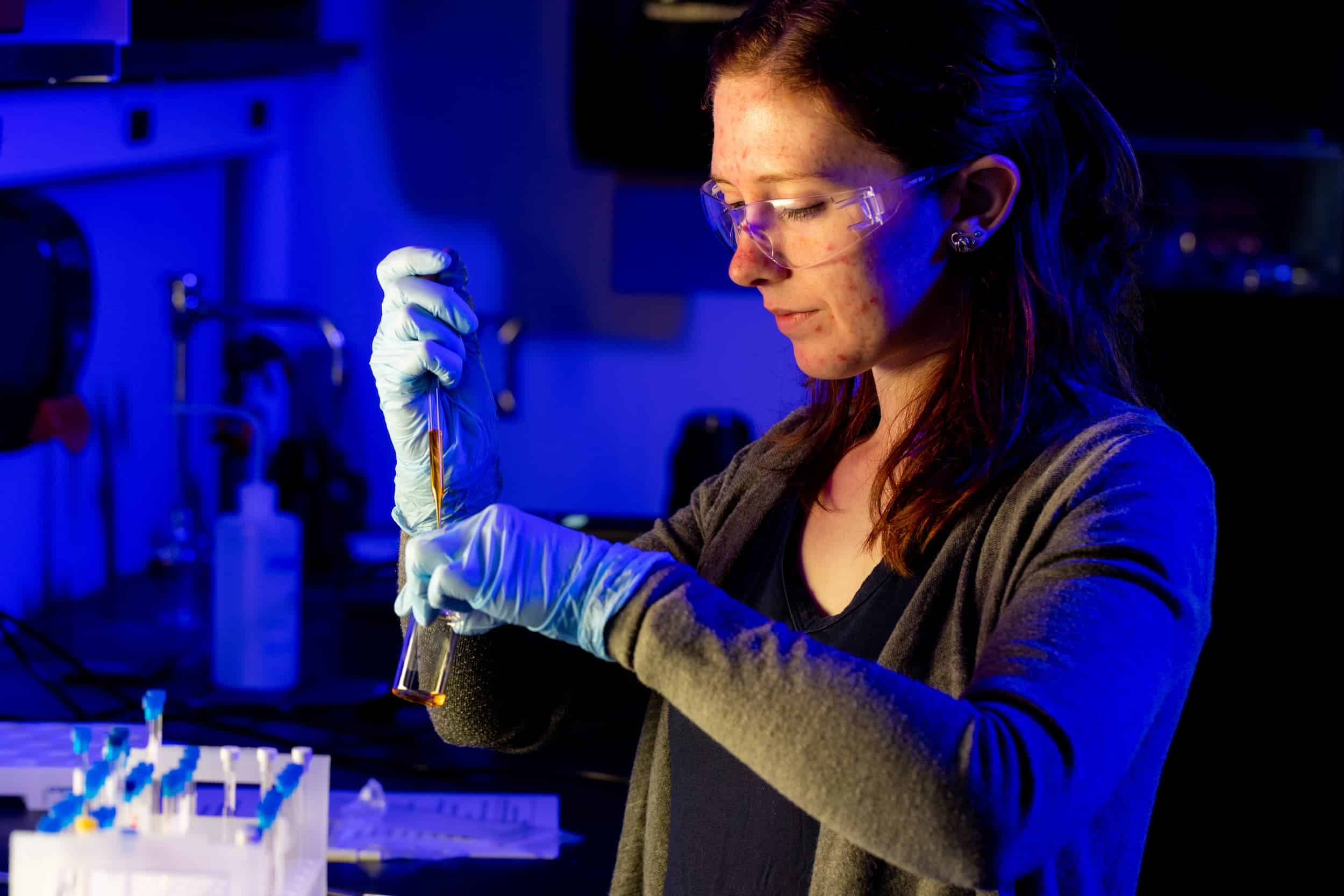 Ali Biery, a post-doc, works with test tubes in the Polymer Characterization Laboratory.