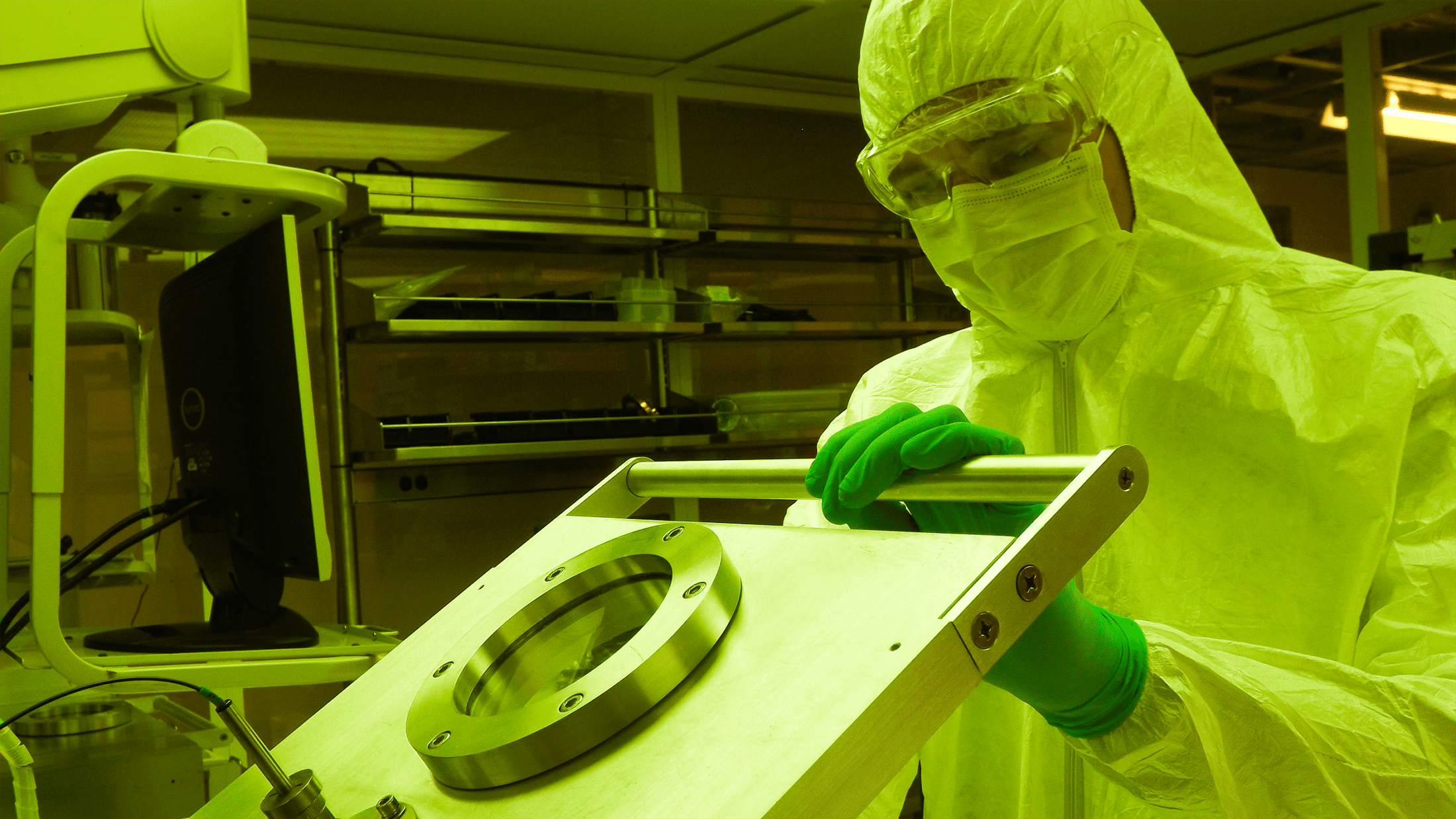 A student wearing protective clothing from head to toe works in the clean room at the Institute for Advanced Materials and Manufacturing.