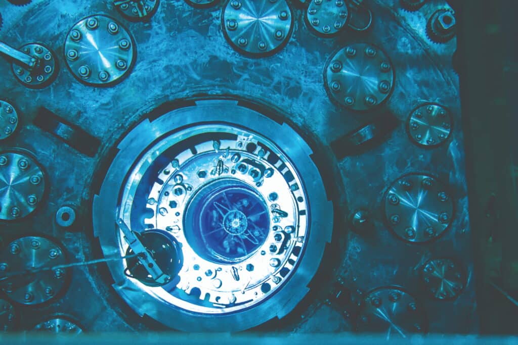 Nuclear reactor in a pool of blue-lighted water.