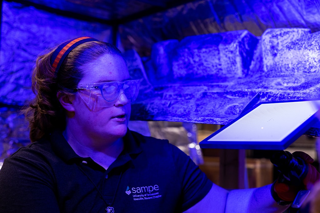Cast in blue light, Hannah Maesser conducts a thermal test for a experimental liftgate for Volkswagen.