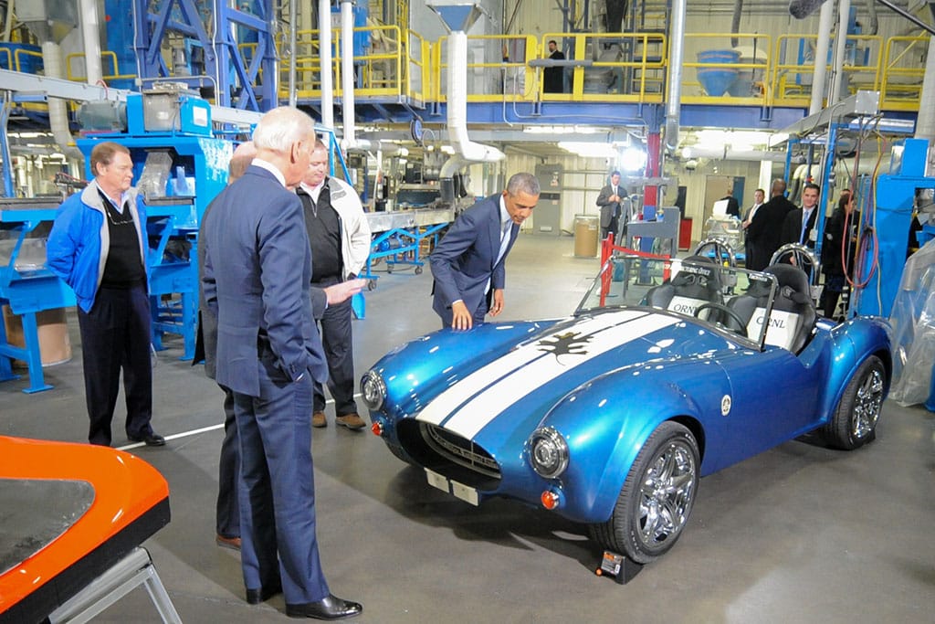 President Obama and then-Vice President Joe Biden look at a blue and white 3D printed sports car at IACMI.