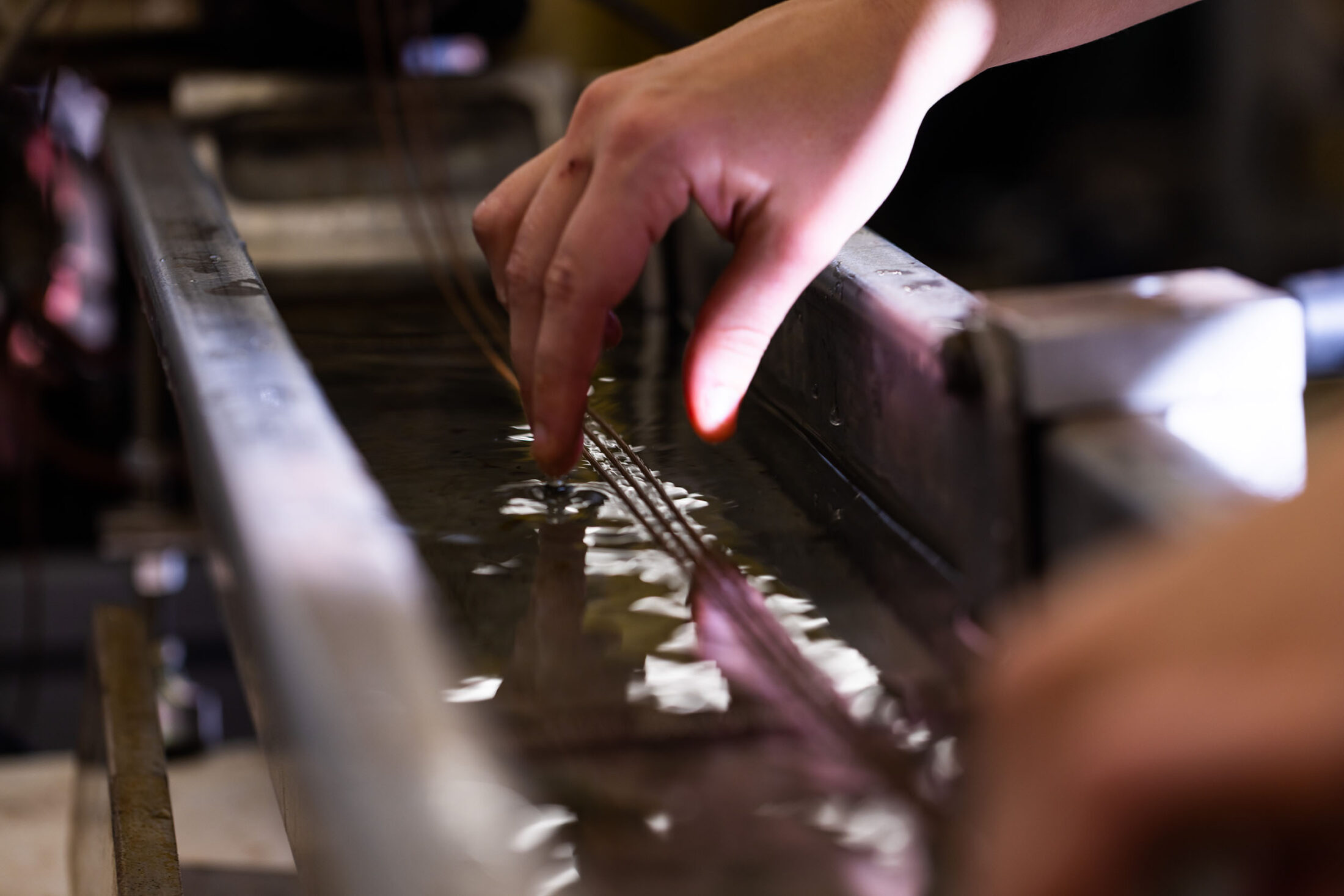 close up of two hands using equipment in a lab in the Center for Renewable Carbon.