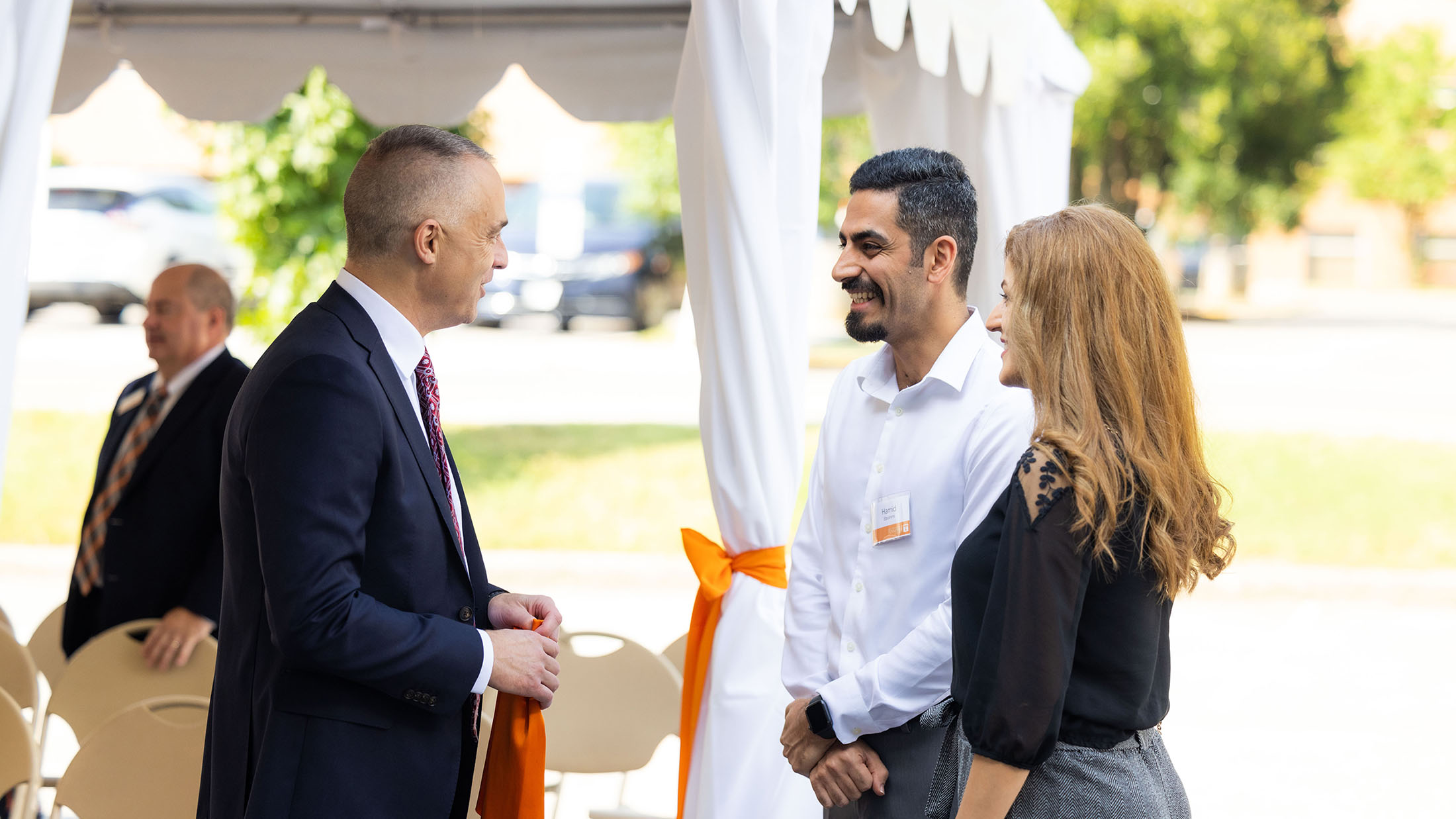 Chris Killian, Eastman Senior Vice President and Chief Technology Officer, visits with attendees during the Eastman Innovation Center dedication.