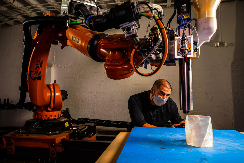 Marshall Prado operates the KUKA robotic arm in the Fab Lab.