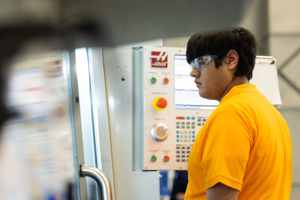 Student operates a machine during the SEC Machining Competition.