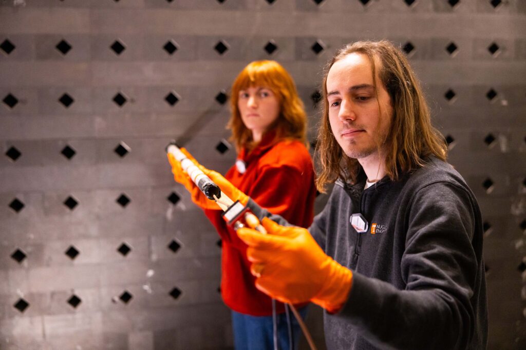 Graduate student Lance Drouet and senior Levi Holler measure plutonium beryllium sources in the Graphite Pile Lab.