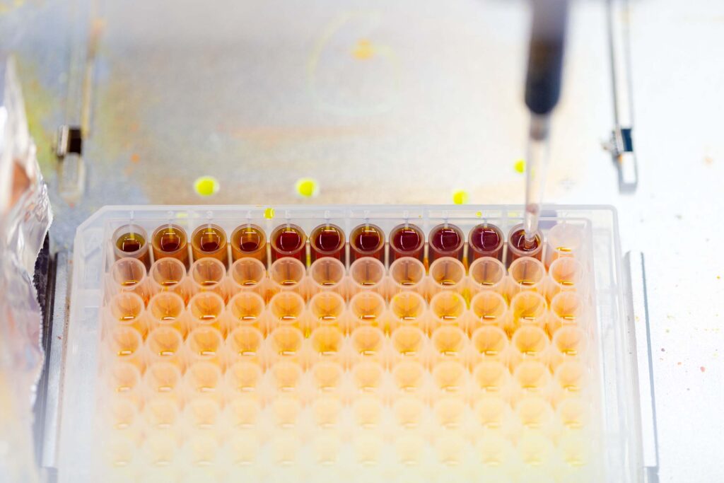 Dozens of tubes filled with brown samples.