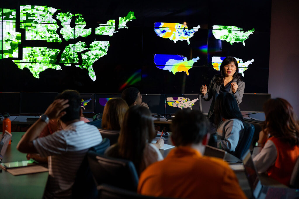 Chien-fei Chen explains her research to a group in CURENT's Visualization Lab.