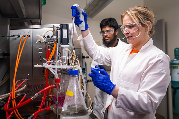 PhD students Carrie Sanford and Galib Hassan Khan begin an experiment in the bioreactor room in Senter Hall at the University of Tennessee.