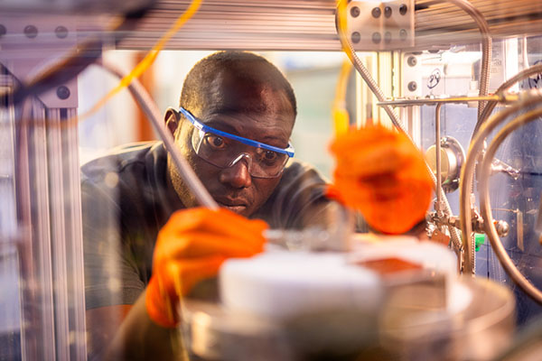 Nourredine Abdoulmoumine works on the CO2-to-jet fuel reactor in the Bioenergy and Biofuels Lab on the Ag campus at the University of Tennessee.