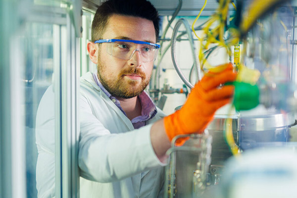 PhD student Conner Pope works on the CO2-to-jet fuel reactor in the Bioenergy and Biofuels Lab on the Ag campus at the University of Tennessee.