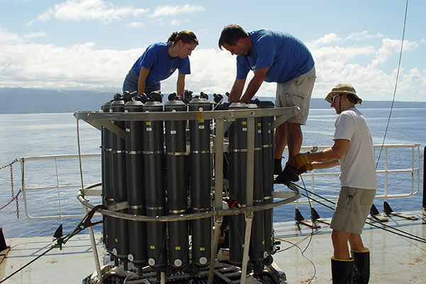 Working on equipment on a ship offshore.