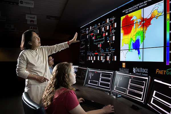 Dr. Yilu Liu analyzing data with her students in the control room of FNET/GridEye system that monitors the nations power grid.