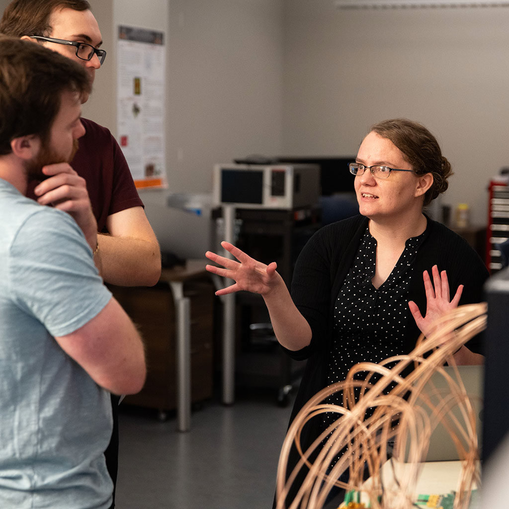 Catherine Schuman instructs two graduate students in the neuromorphic computing lab.