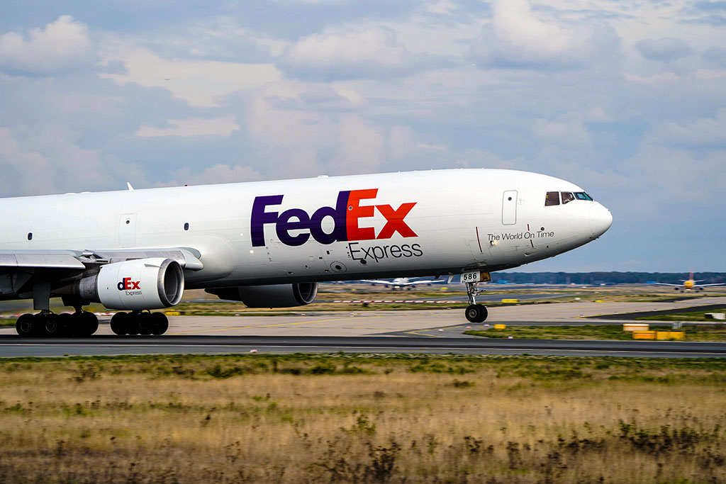 FedEx airplane on the runway of an airport; photo provided by Jan Rosolino on Unsplash.