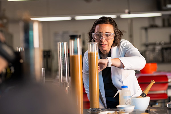 Lecturer Sarah Mobley tests soil samples using a hydrometer in a lab in the John D. Tickle Engineering Building at the University of Tennessee.