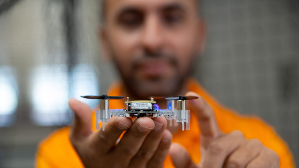 A PhD student holds a nano drone in the Autonomous Systems Laboratory in the Nathan W. Dougherty Engineering Building at the University of Tennessee.