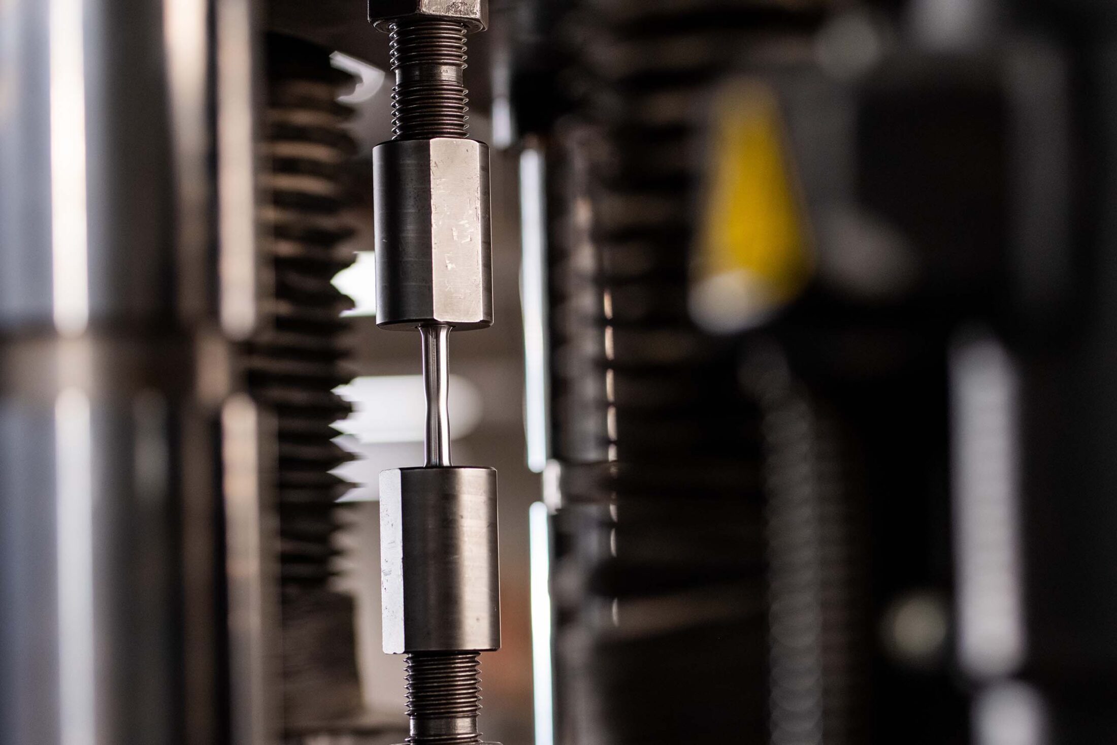 Close up of a steel bolts being tested with an Instron Universal Testing Machine.
