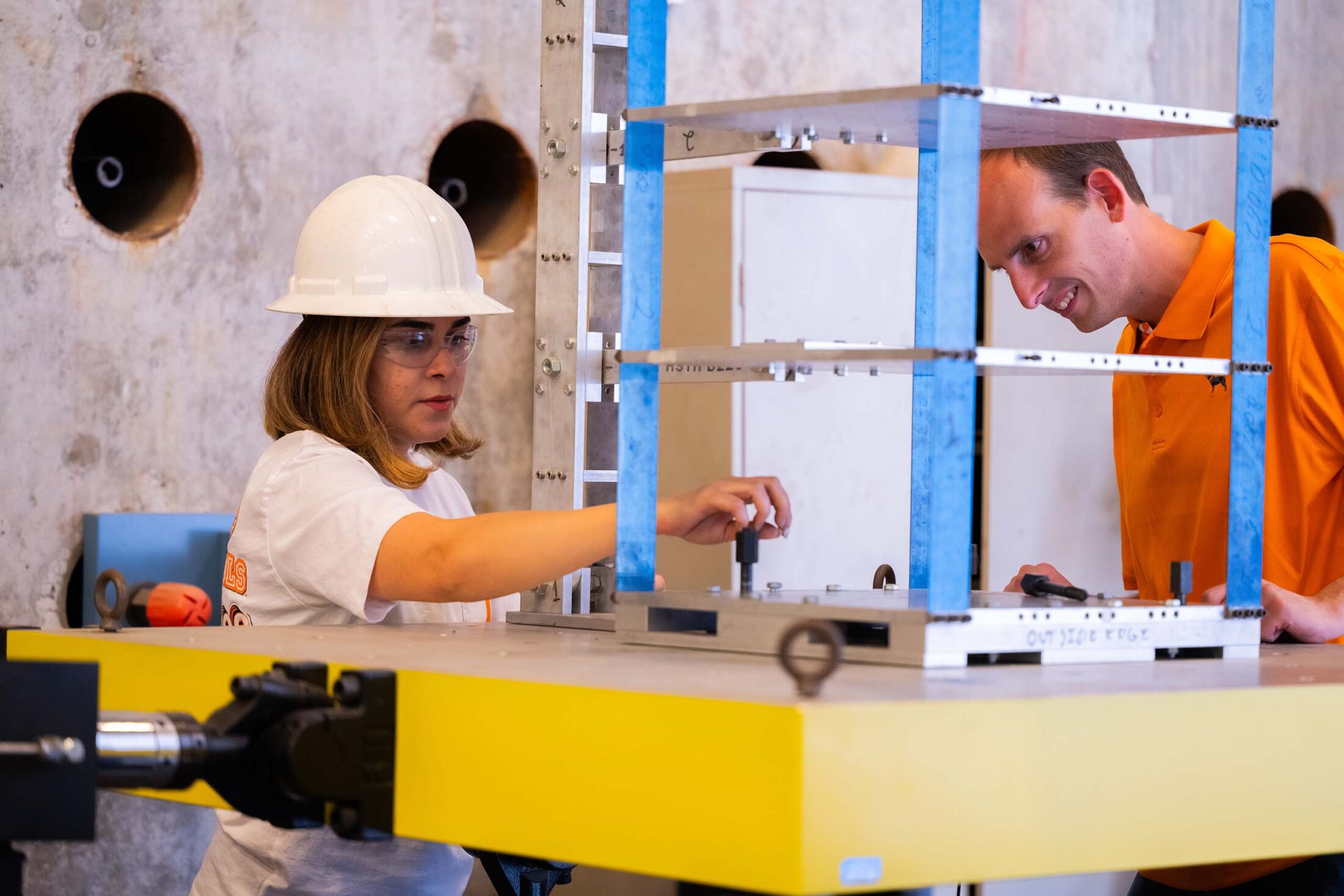 Nick Wierschem and a graduate student install a structure on a shake table.