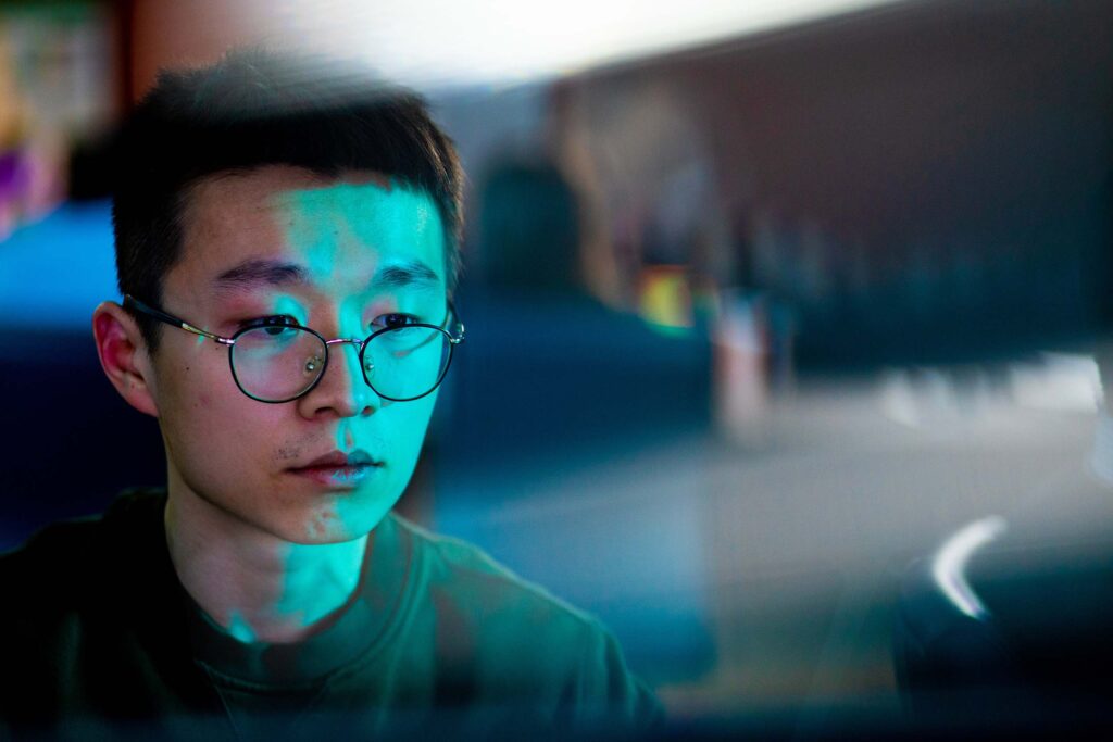 A man wearing glasses works in CURENT's visualization lab.