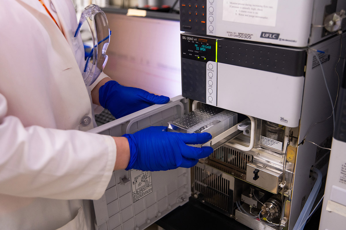 A student uses the high-performance liquid chromatography in a lab.