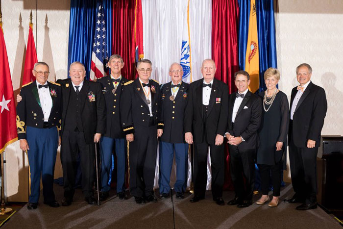 The 2018 Army ROTC Alumni Council Hall of Fame inductees: retired Colonel Mark D. Boyatt, retired Major Terry A. Griswold, retired Colonel Mark N. McDonald, retired Brigadier General Geoffrey A. Freeman, retired Lieutenant Colonel George M. Massey, retired Colonel Robert D. Pickle, retired Colonel Gregory P. Gass, Jane Neall (accepting on behalf of retired Lieutenant Thomas Johnson), and Alan D. Wilson. Not pictured: Linda Vaughn accepting on behalf of her late husband, Emmet P. (Buck) Vaughn. Photo by Steven Bridges