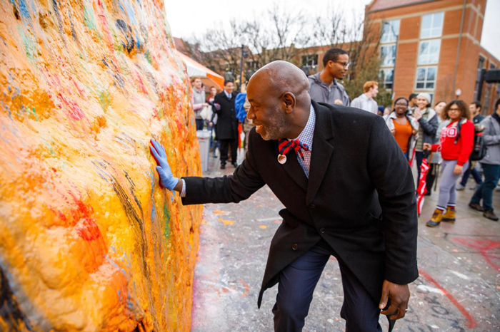 Tyvi Small, vice chancellor for diversity and engagement, places his handprint on the Rock on February 20, 2019. Photo by Steven Bridges
