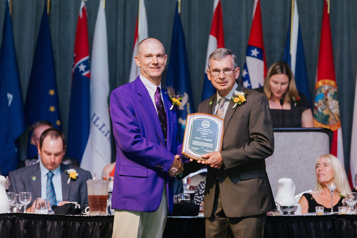 John Campbell, above right, is pictured receiving the Hall of Fame Award from the National Association of County Agricultural Agents president, Richard Fechter. Campbell is one of four recipients, one from each region. Image courtesy NACAA. Download image​.