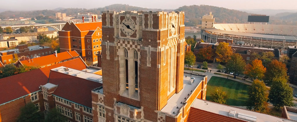 Aerial view of Ayres Hall, which has a clock and is made of red brick with white adornment.