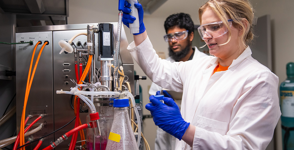 Carrie Sanford and Galib Hassan Khan begin an experiment in the bioreactor room.