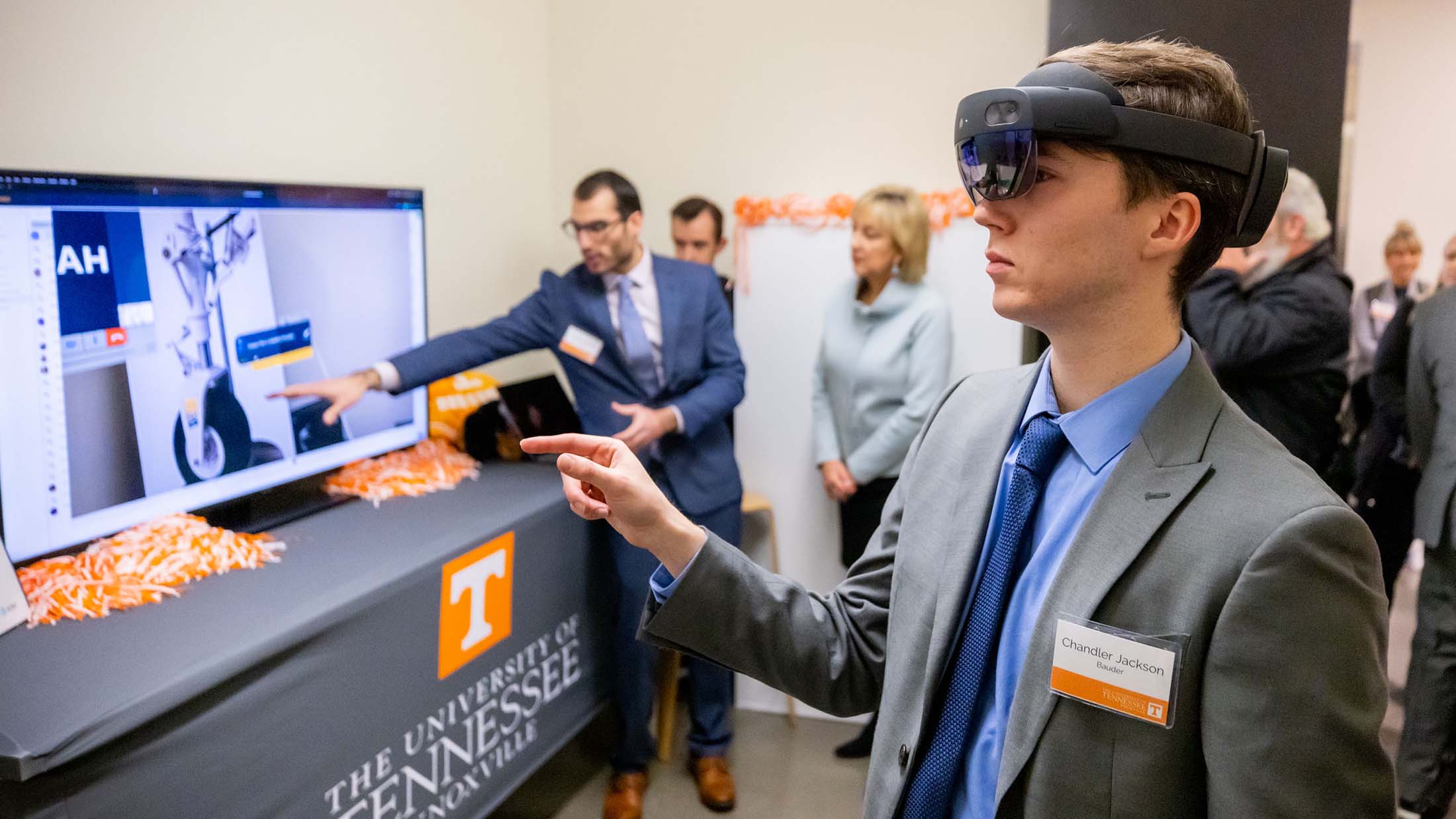 Student wears VR goggles, demonstrating the technology available at the new AT&T lab at UT.