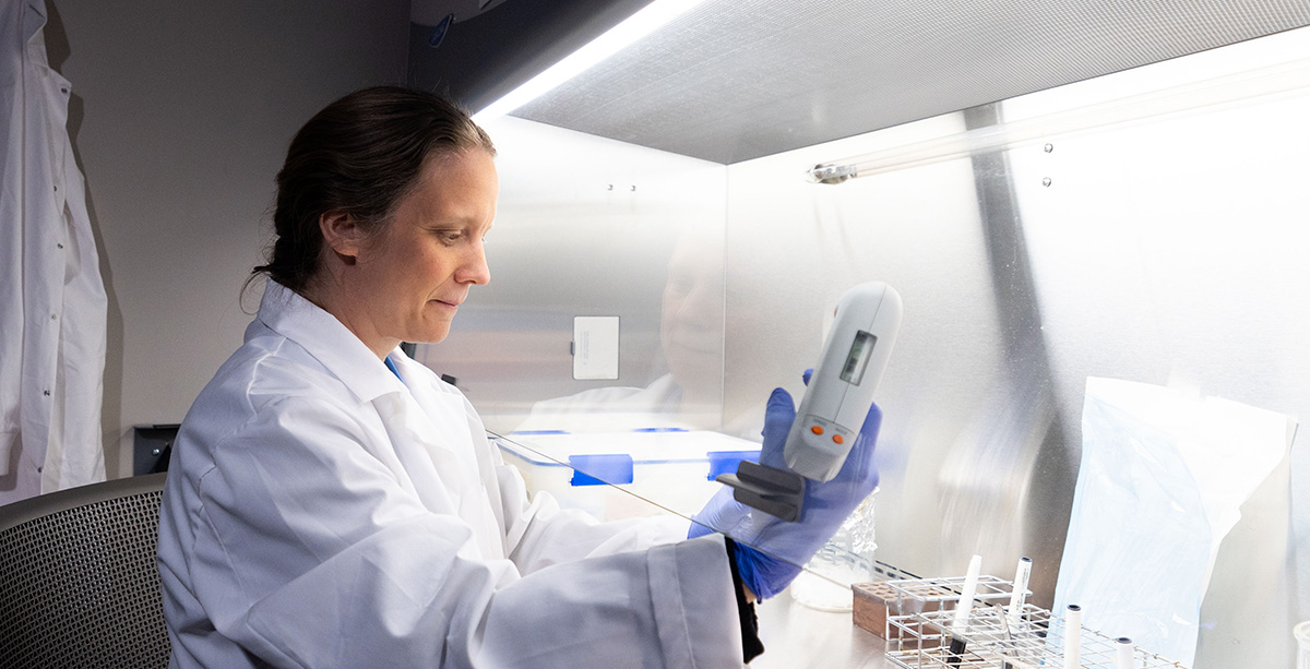 Rachel Patton McCord works at a hooded station in her lab.