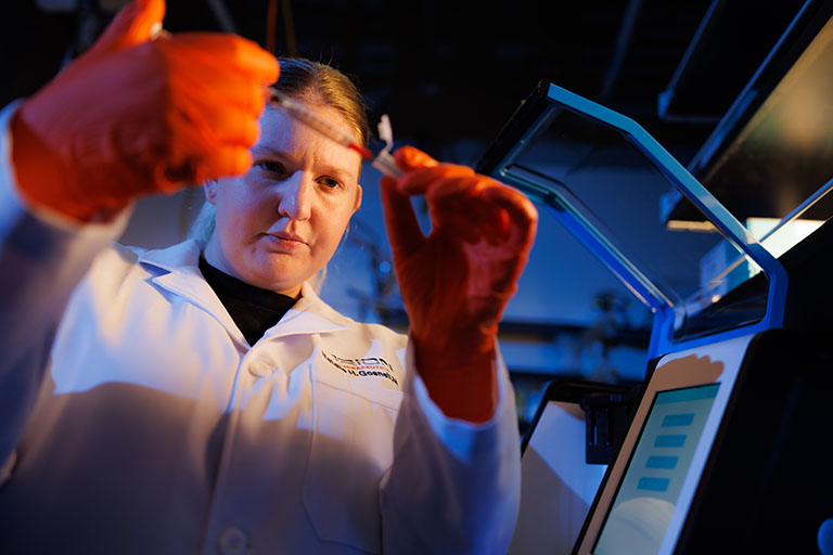 Alumna Natalie Gosnell (BS biomedical engineering ’19, MBA ’23) works in an Orion Therapeutics pharmaceuticals lab in the Institute for Advanced Materials and Manufacturing.