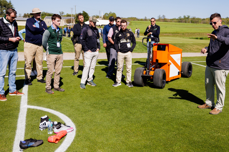 Research Associate Kyley Dickson gives a presentation on the shallow pitch profile and the fLEX Device during the FIFA Field Day and Club World Cup Workshop.