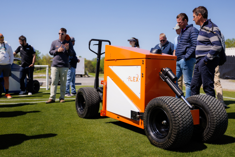 Research Associate Kyley Dickson gives a presentation on the shallow pitch profile and the fLEX Device during the FIFA Field Day and Club World Cup Workshop.