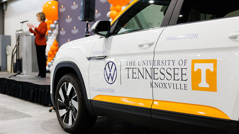 A volkswagen SUB with University of Tennessee, Knoxville and Volkswagen decals on the side.